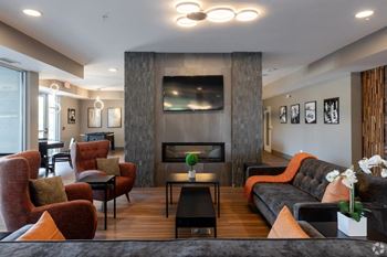 a living room with couches and chairs and a fireplace